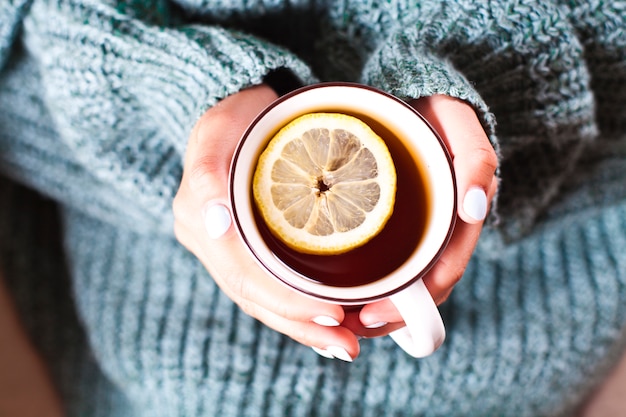 Young woman relaxing with tea cup on hand