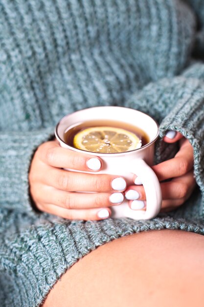 Young woman relaxing with tea cup on hand