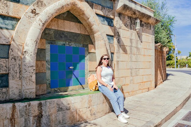 Young woman resting at the ancient site in Old City of Akko Israel