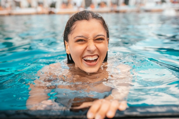 Young woman resting on the edge of swimming pool