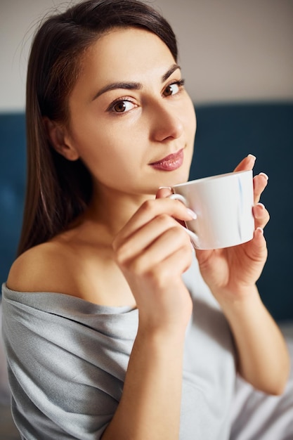 Young woman resting and spending weekend at home alone at home