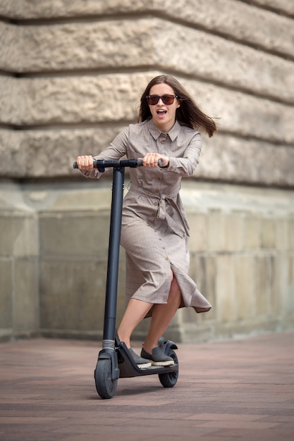 Young woman riding an electric scooter