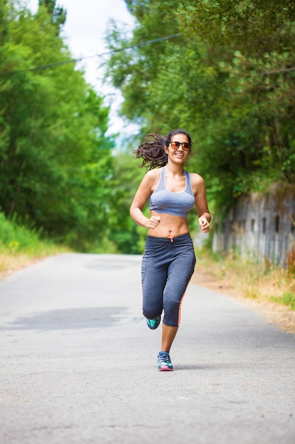 young woman running in the forest