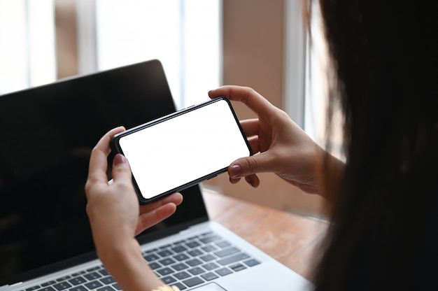 Young woman's h holding  looking mobile phone.