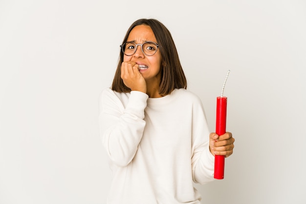 Young woman scared holding dynamite