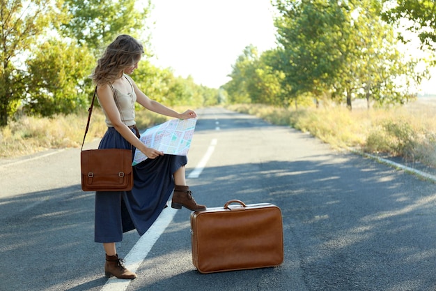 Young woman searching direction on map