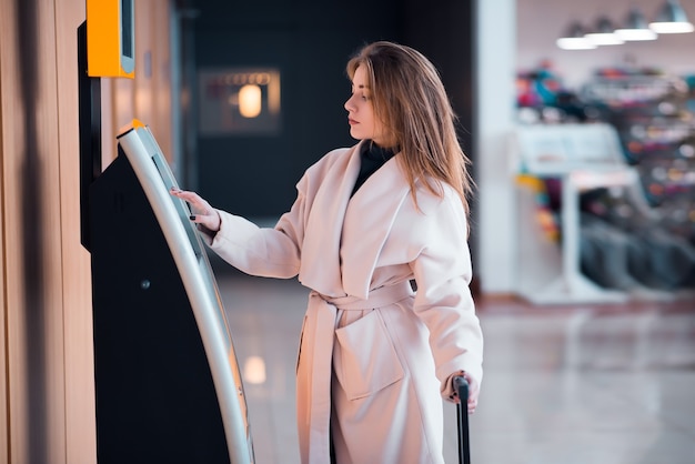 Young woman at self service transfer area.