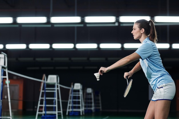 Young Woman Serving Shuttlecock