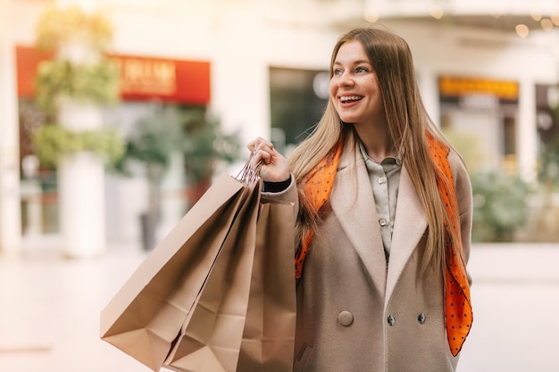 Young woman in shopping Happy woman with shopping bags enjoying in shopping