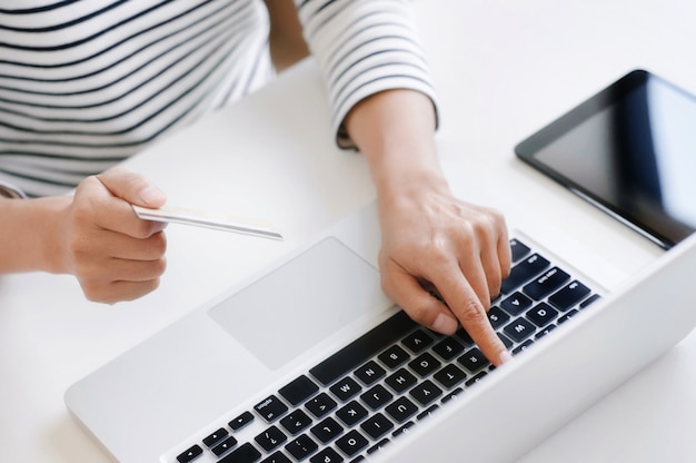 Young Woman Shopping Online With Debit / Credit Card, payment and marketing concept