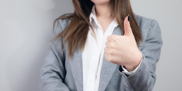 Young woman showing thumb up