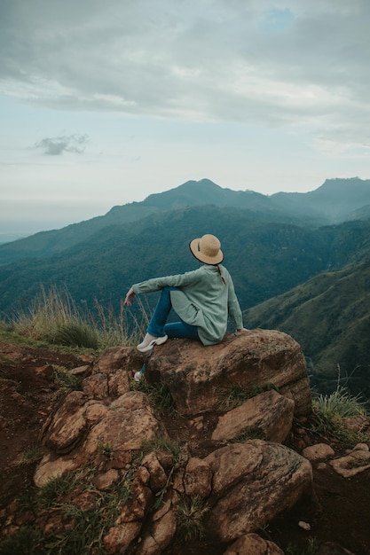 Young woman sits on little adam's peak