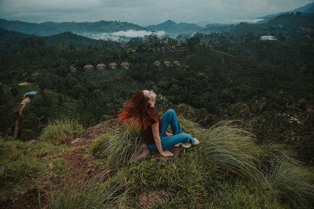 Young woman sits on little adam's peak