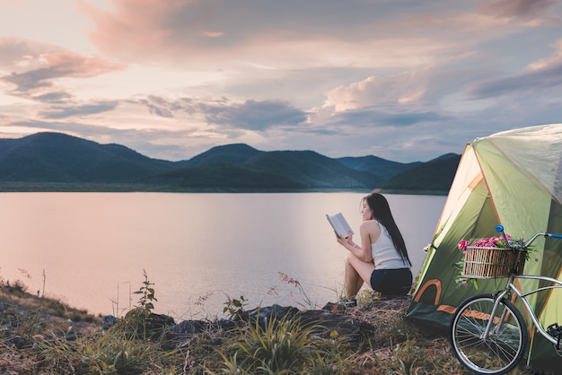 Young woman sitting near the lake 