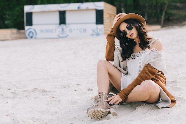 Young woman sitting on sand