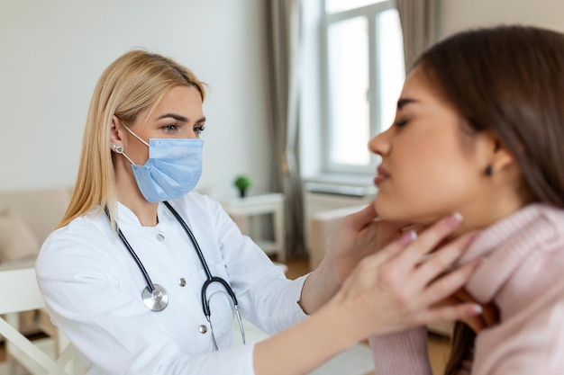 Young woman sitting while the nurse examining her throat physician checking patient thyroid gland health examination in hospital