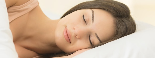 The young woman sleeping on the bed