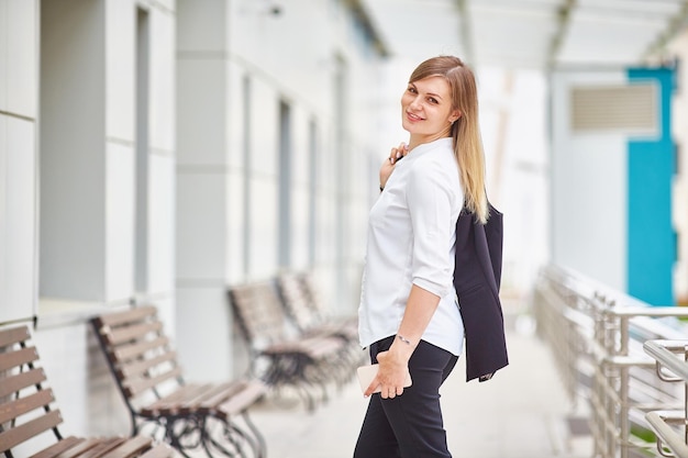 Young woman smiles at the camera looking back Manager or businesswoman Copy space