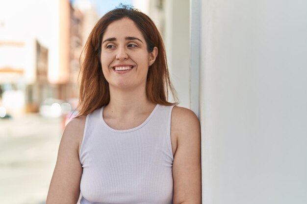 Young woman smiling confident standing at street