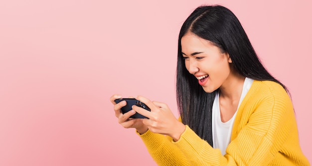 young woman smiling excited using mobile phone say yes