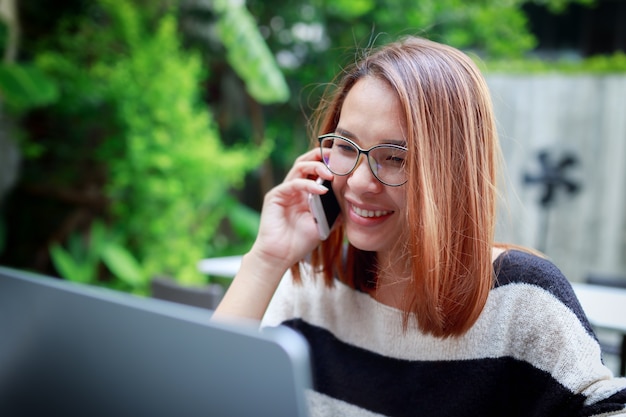 Young woman smiling happy using smartphone 