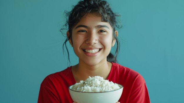 Photo young woman smiling while holding bowl of cooked rice