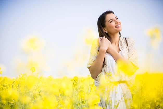 Young woman in the spring field