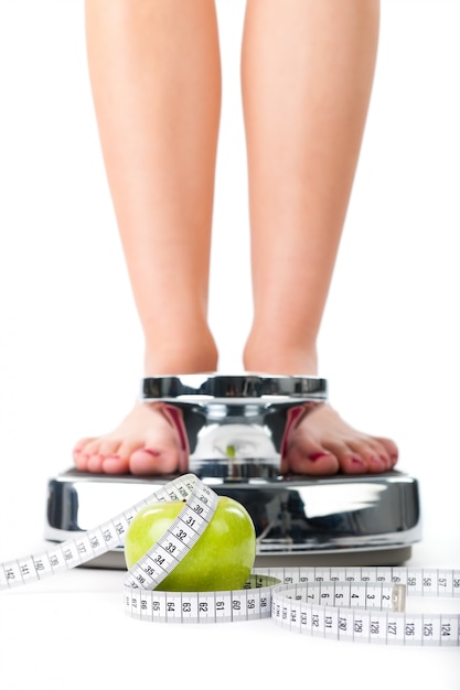 Young woman standing on a scale