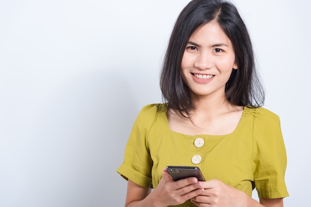 Young woman standing smile holding smartphone