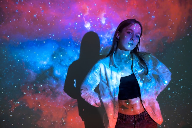 Young woman standing in universe texture projection