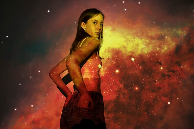 Young woman standing in universe texture projection