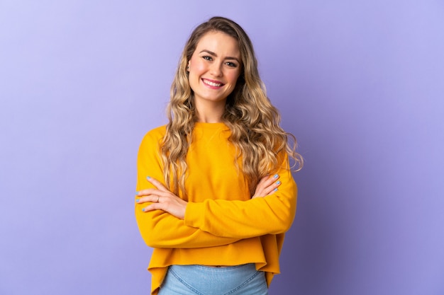 Young woman standing with her arms crossed