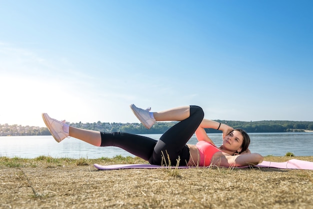 Young woman streching legs early morning before working time on outdoor.