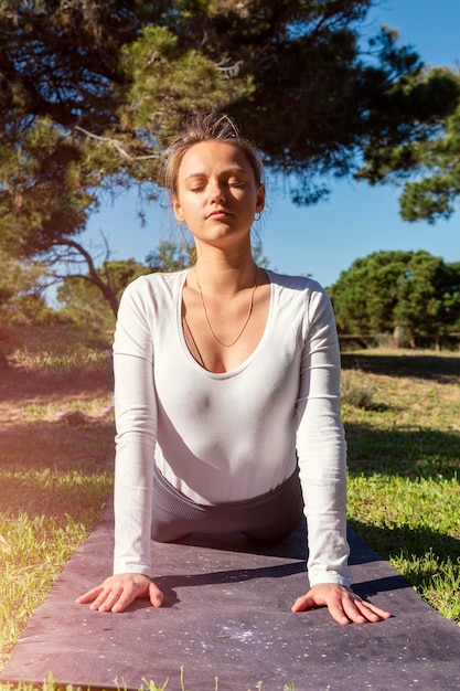 Young woman stretching in the forest