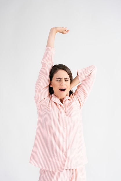 Young woman stretching and yawning