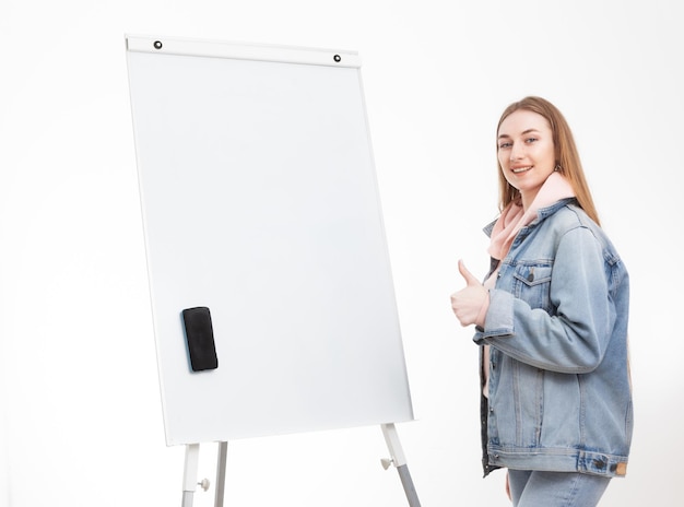 Young woman student in denim clothes and white board isolated on white background Education concept