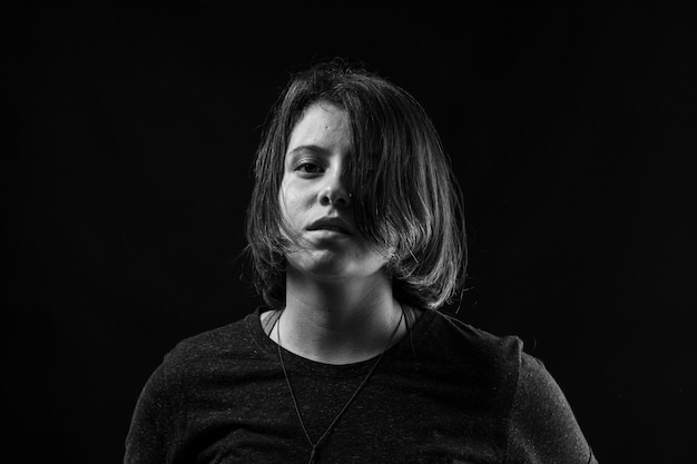 Young woman in studio black and white photo