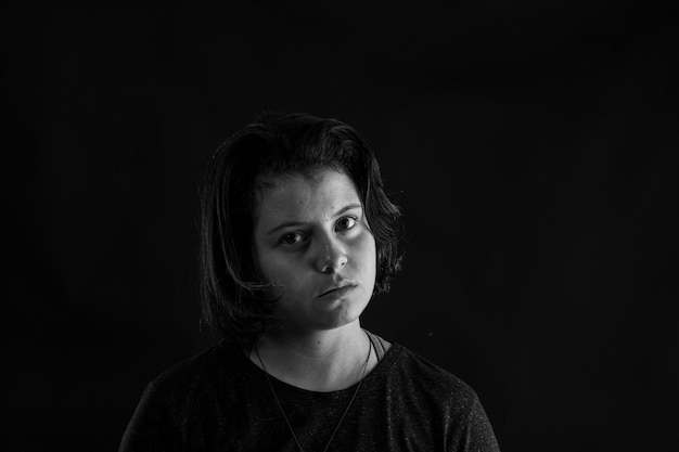 Young woman in studio black and white photo