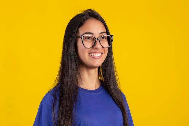 Young woman in studio photo wearing shirt and glasses