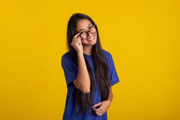 Young woman in studio photo wearing shirt and glasses