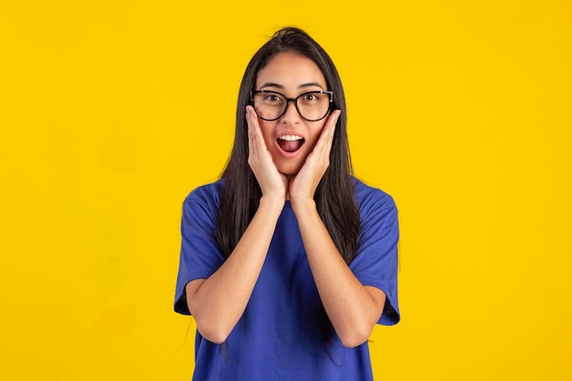 Young woman in studio photo wearing shirt and glasses