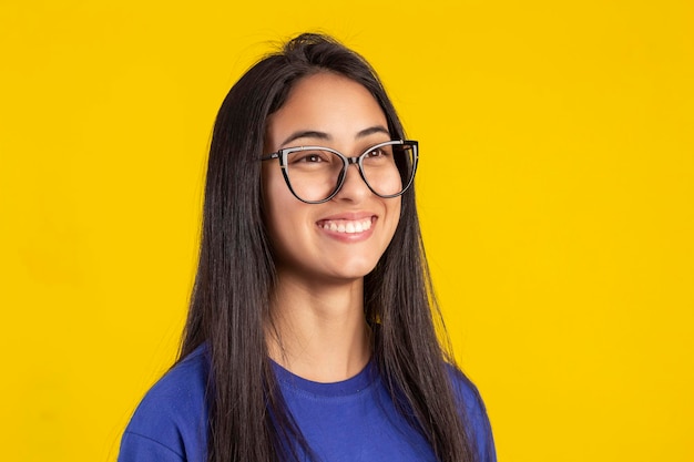 Young woman in studio photo wearing shirt and glasses