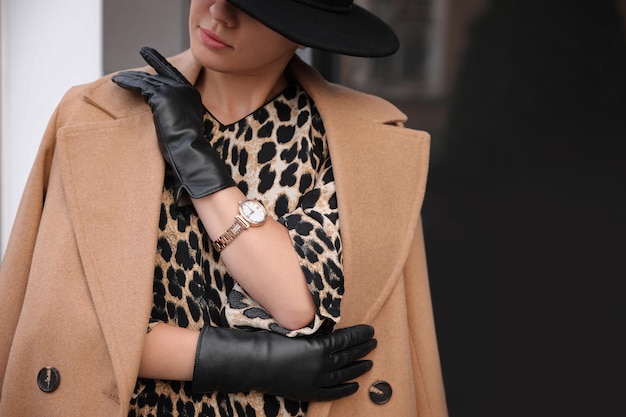 Young woman in stylish black leather gloves outdoors