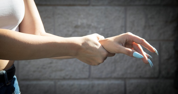 Young woman suffering from pain in hand