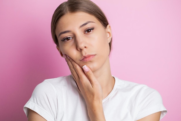 Young woman suffering from toothache tooth decay or sensitivity