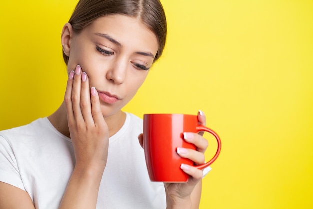 Young woman suffering from toothache tooth decay or sensitivity