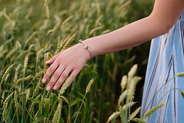 Young woman in summer in a wheat field