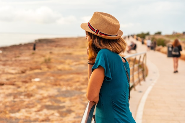 A young woman at sunset on the Paseo de Poniente in San Antonio Abad Ibiza Island Balearic