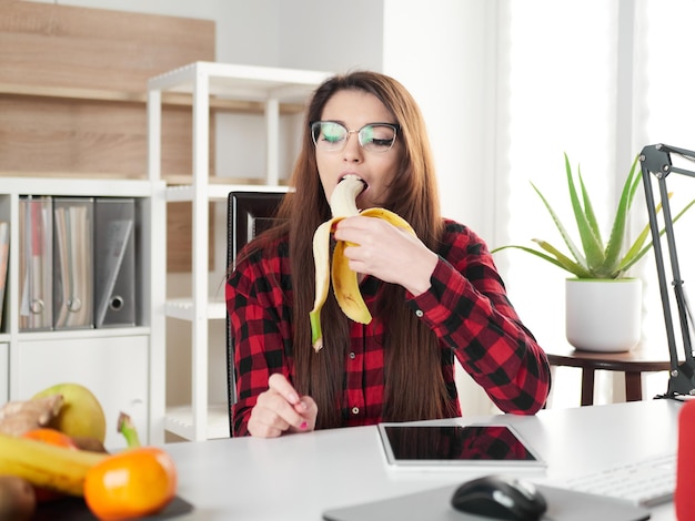 Young woman take a break and eat a banana fruit