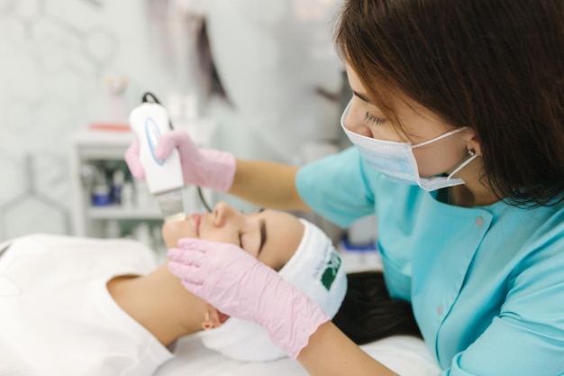 Young woman taking beauty procedure in spa salon